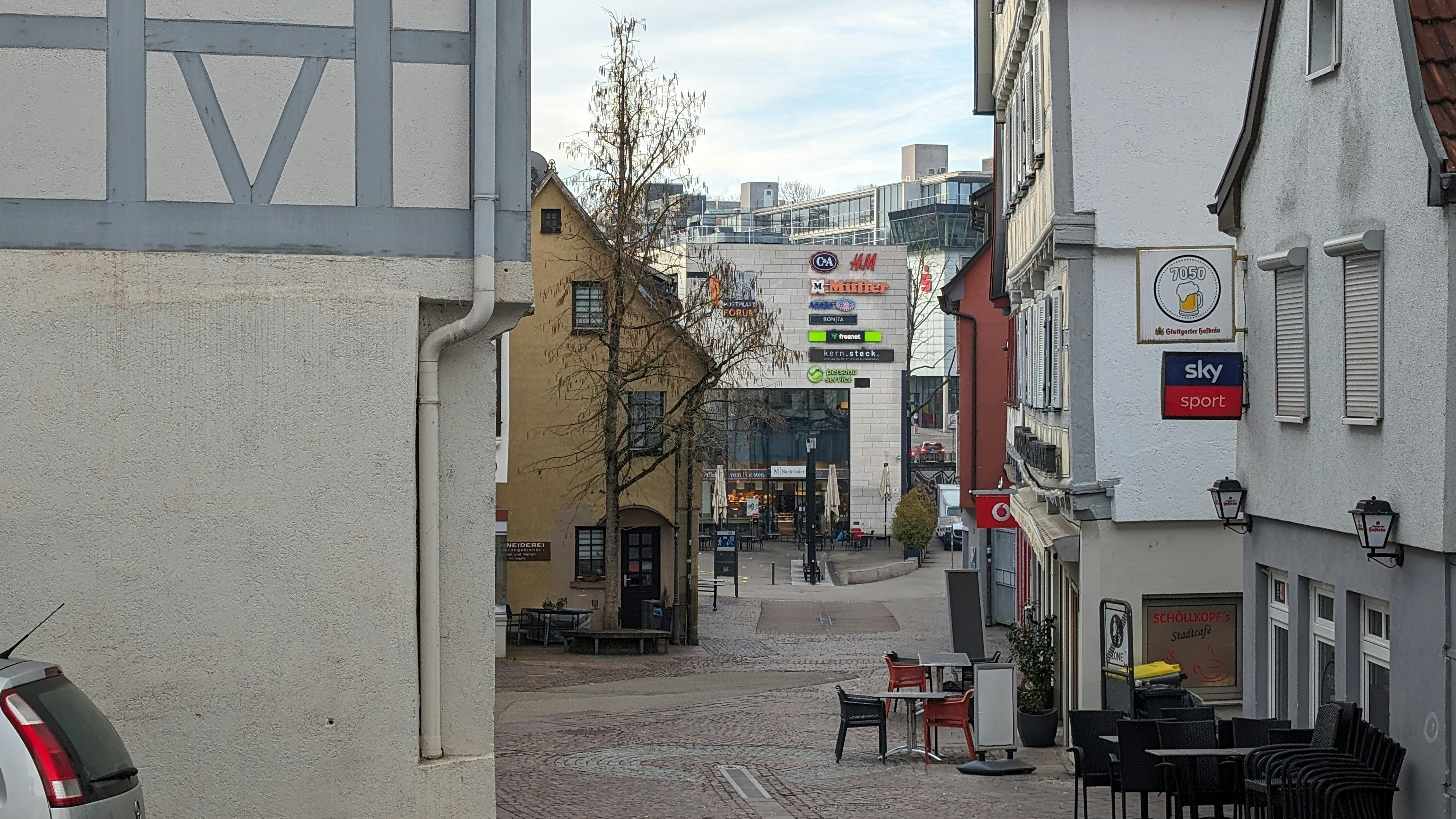 a narrow city street with a few buildings on both sides