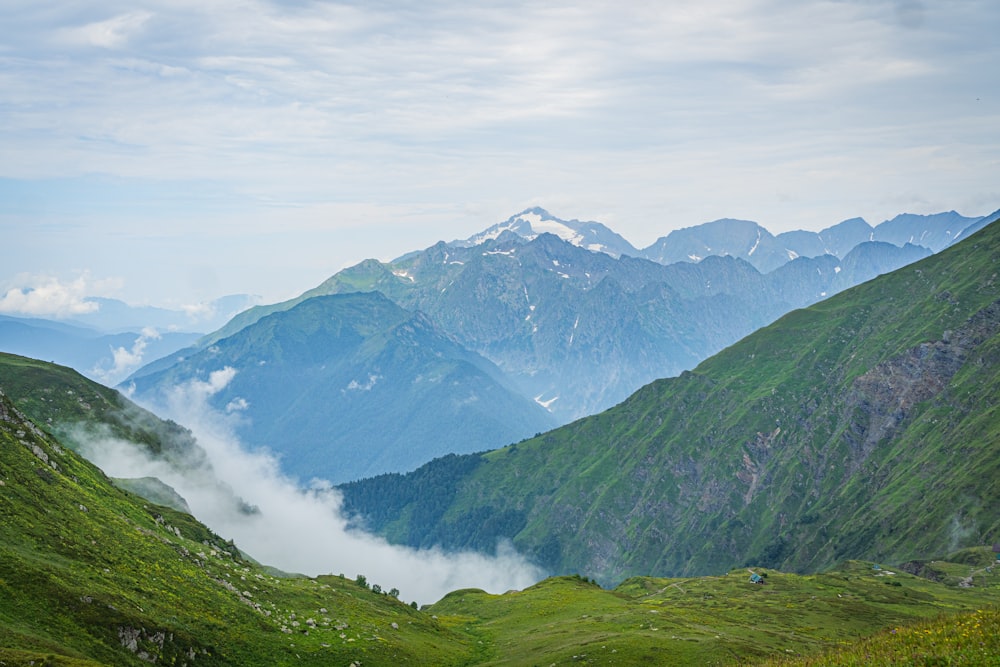 a view of a valley with mountains in the background