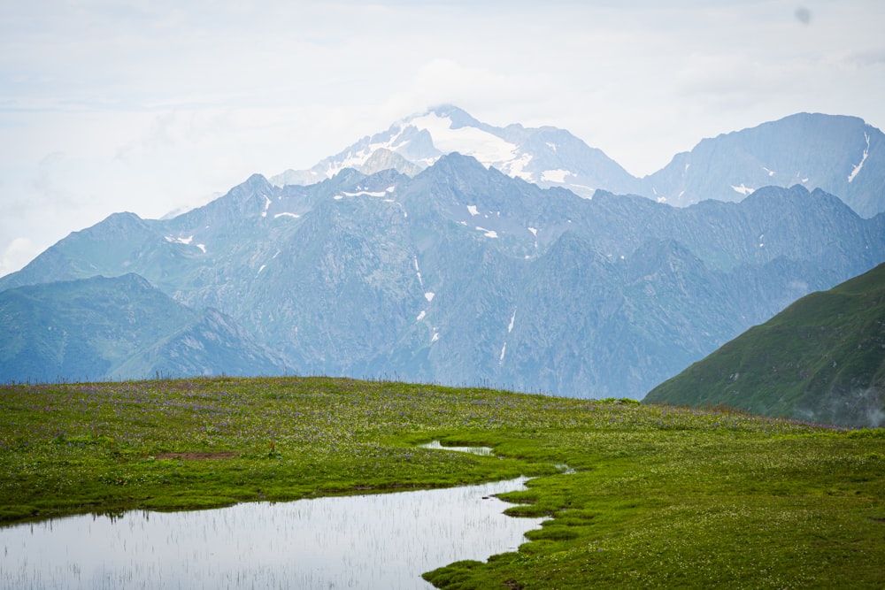 a mountain range with a body of water in the foreground