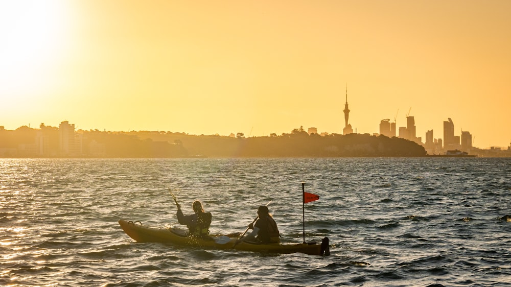 a couple of people in a small boat on a body of water