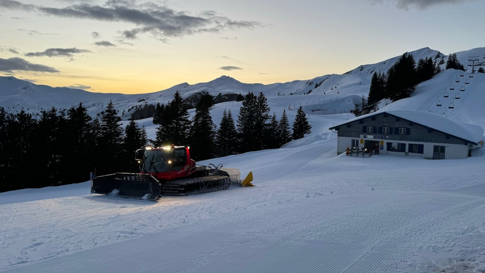 a snow plow sitting in the middle of a snow covered field