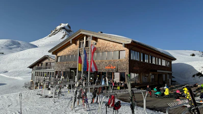 a group of people standing outside of a ski lodge