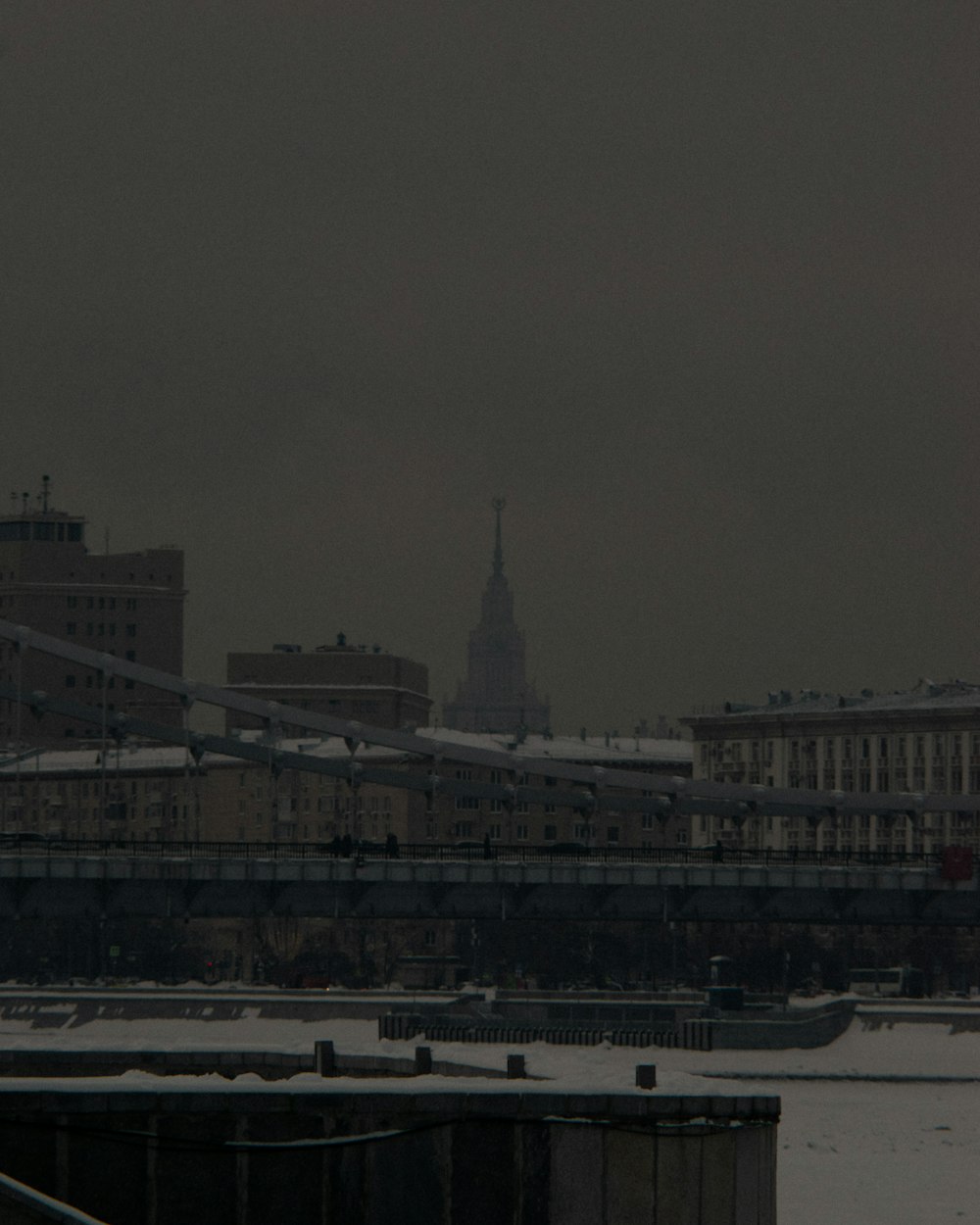 an airplane is flying over a bridge in the snow