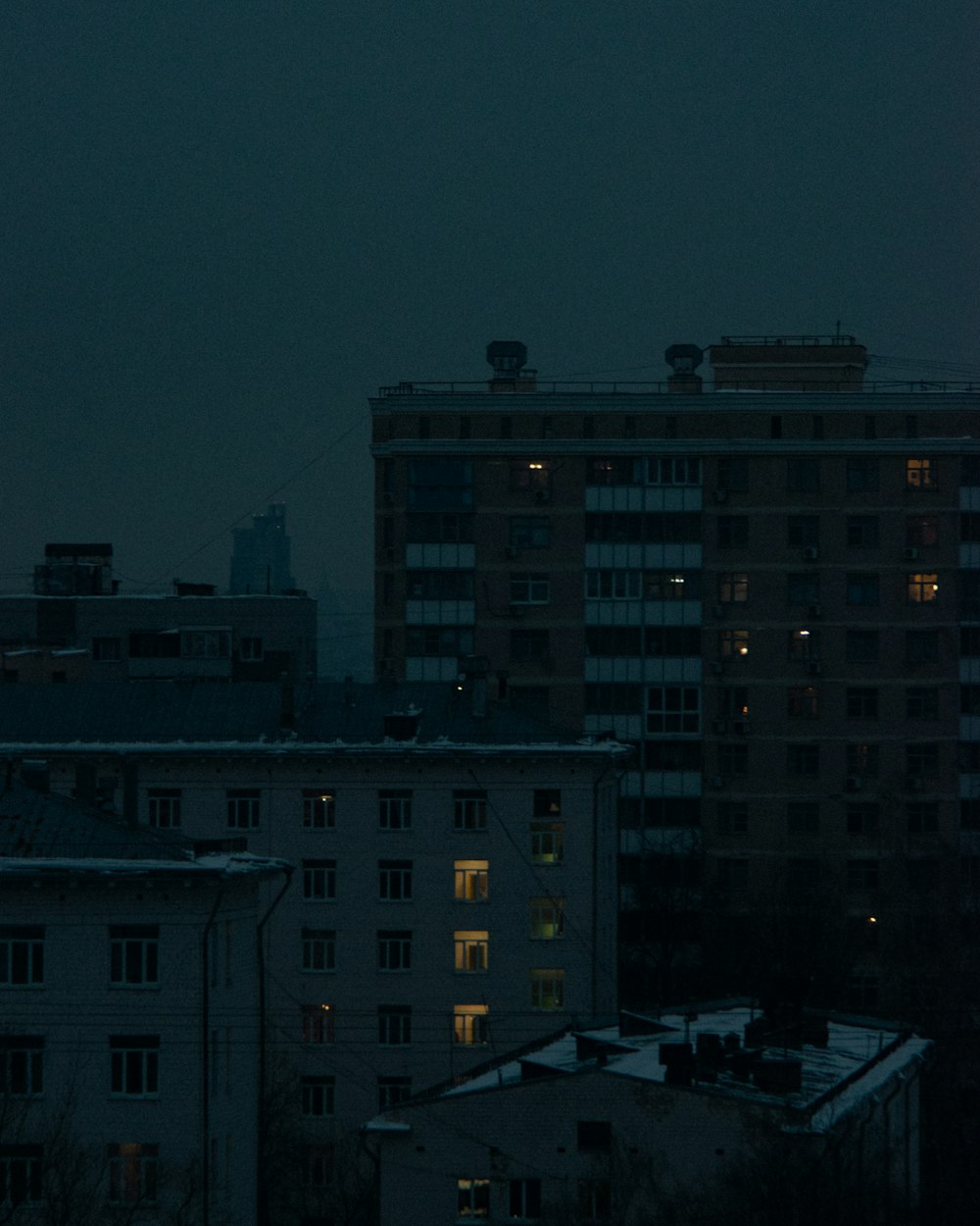 a full moon is seen over a city at night