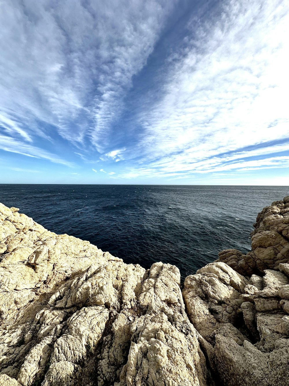 a view of the ocean from a rocky outcropping