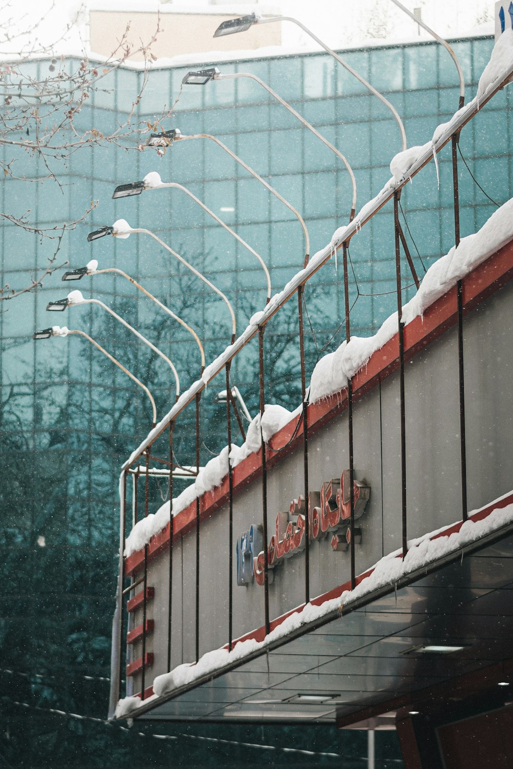 a red and white train on a train track covered in snow