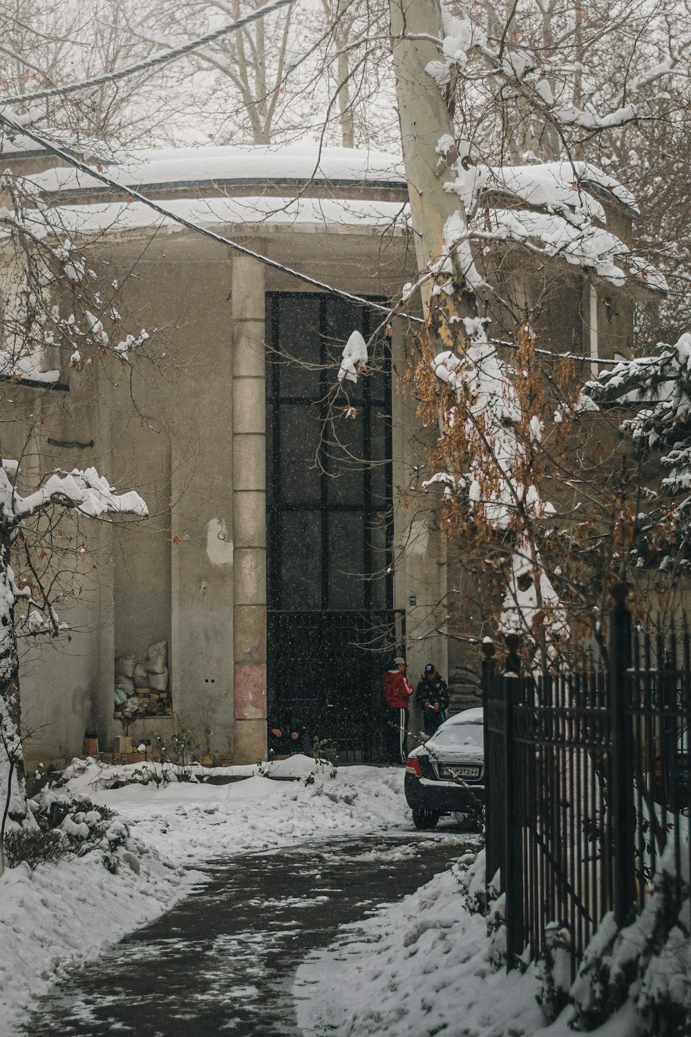 a car parked in front of a building covered in snow