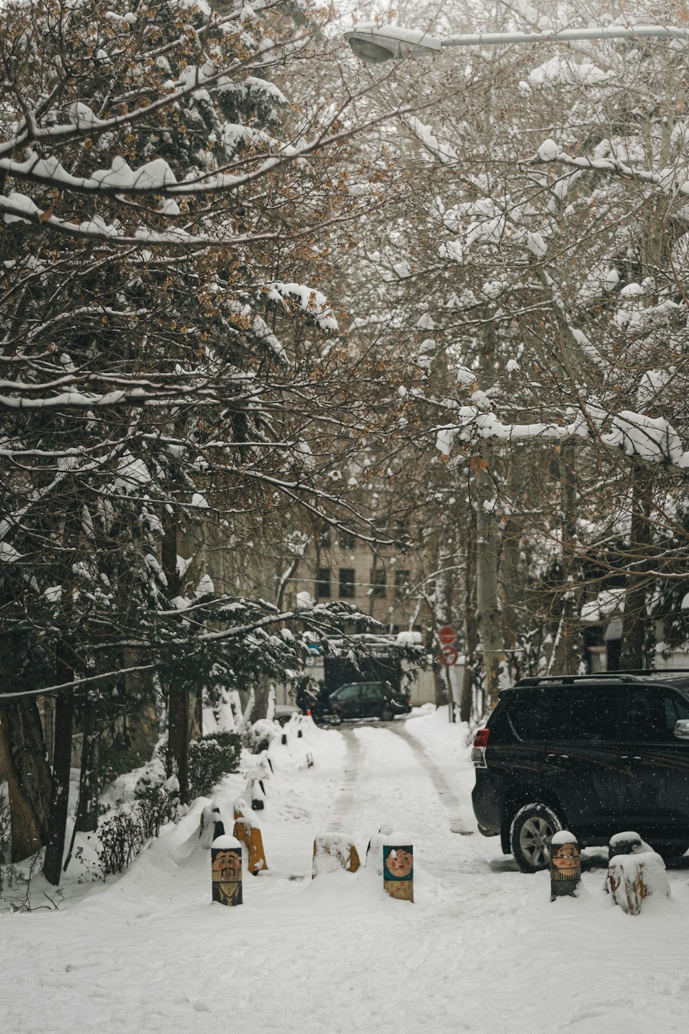 a black truck is parked on a snowy street