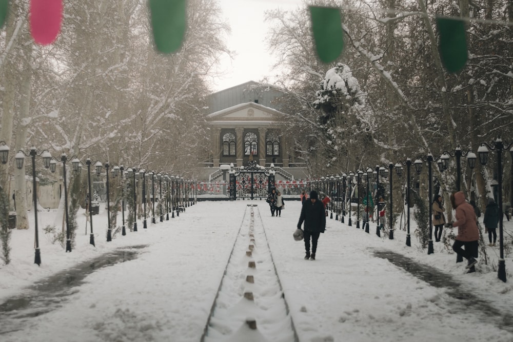 a group of people walking down a snow covered walkway
