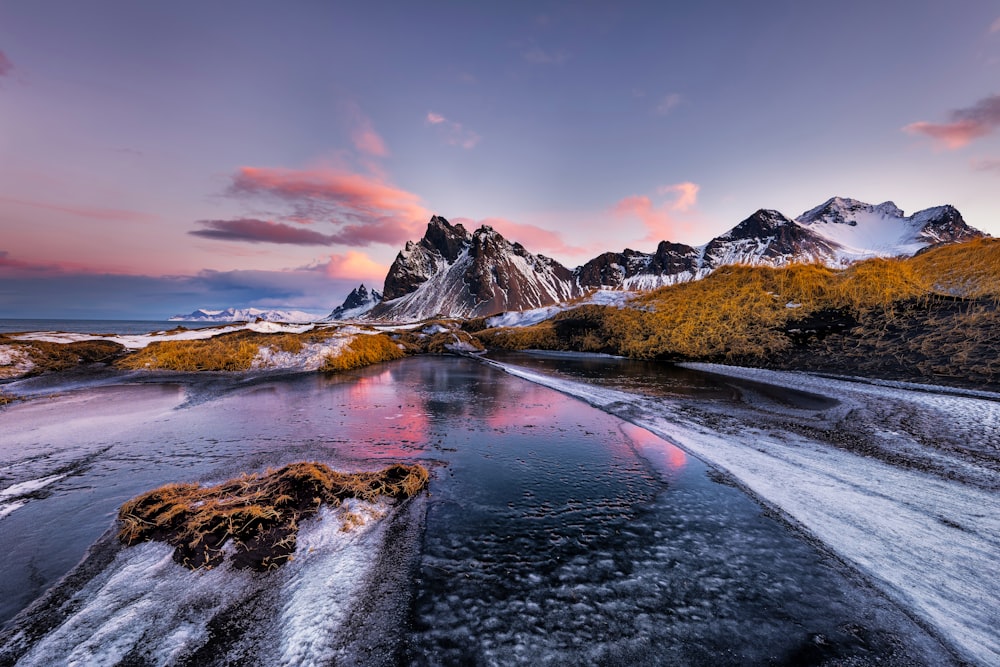 a river running through a snow covered mountain range