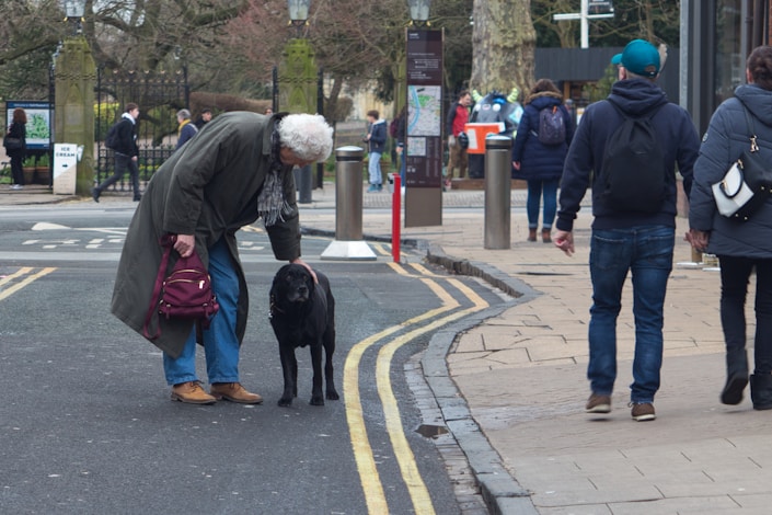 a man with a dog on a city street