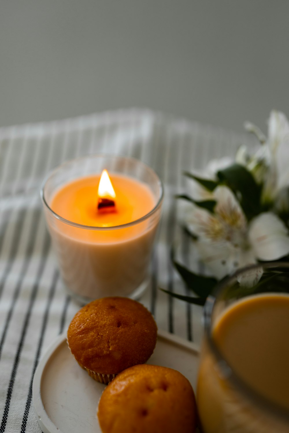 a plate with a muffin and a candle on it