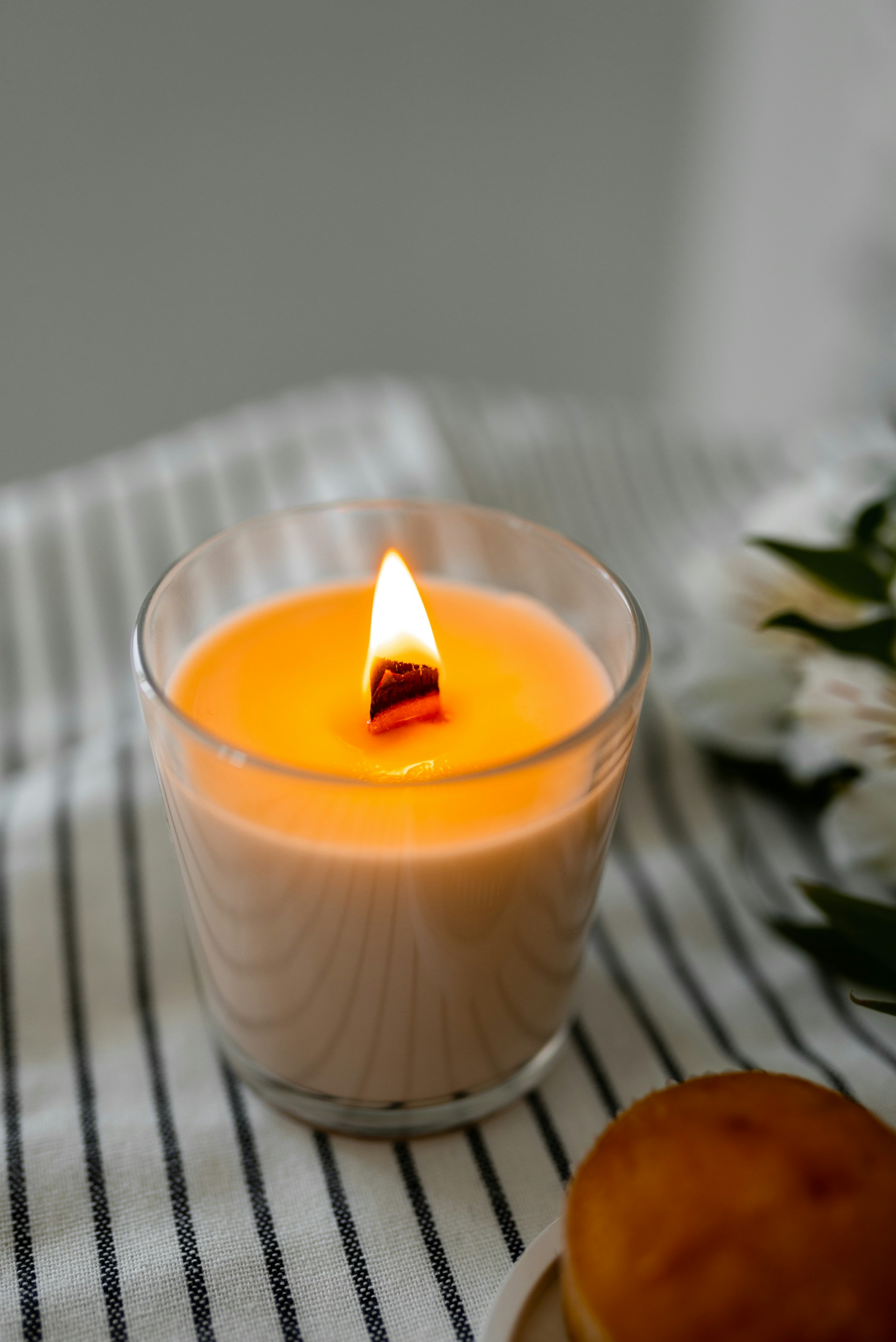 a lit candle sitting on top of a table