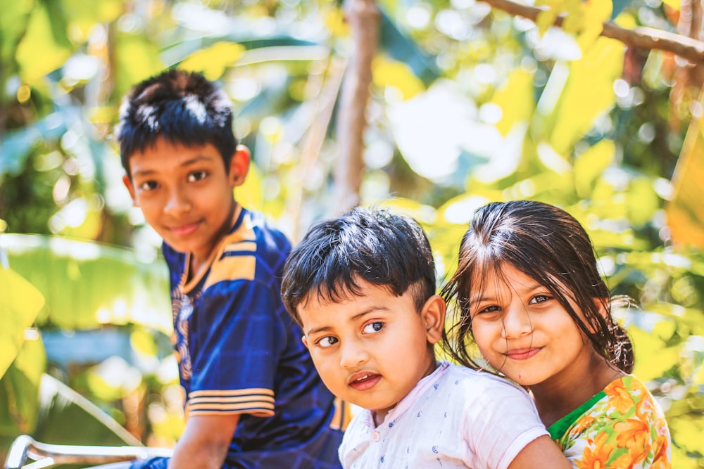 a group of young children sitting next to each other