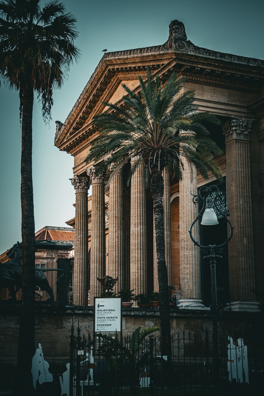 a tall building with a palm tree in front of it