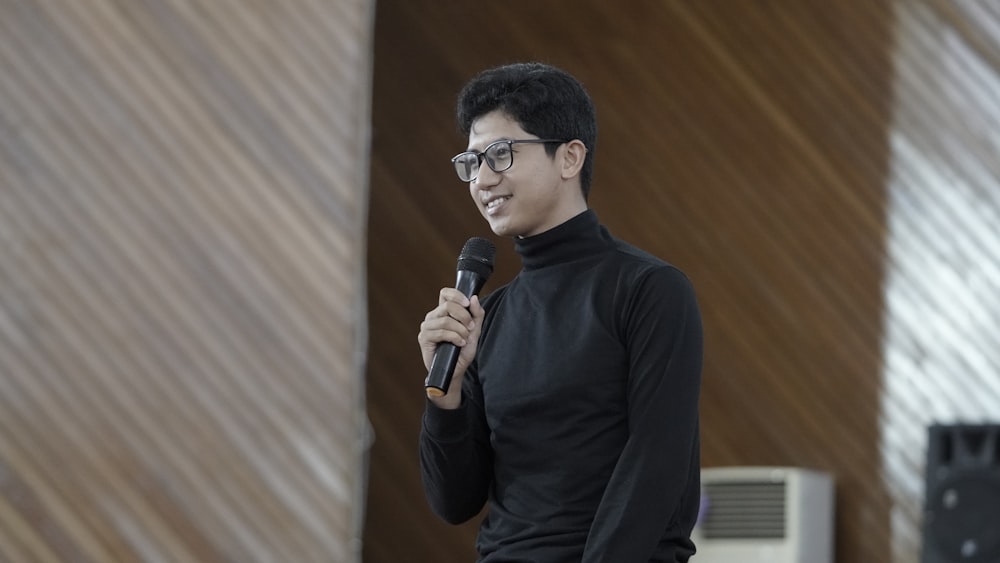 a man standing in front of a microphone