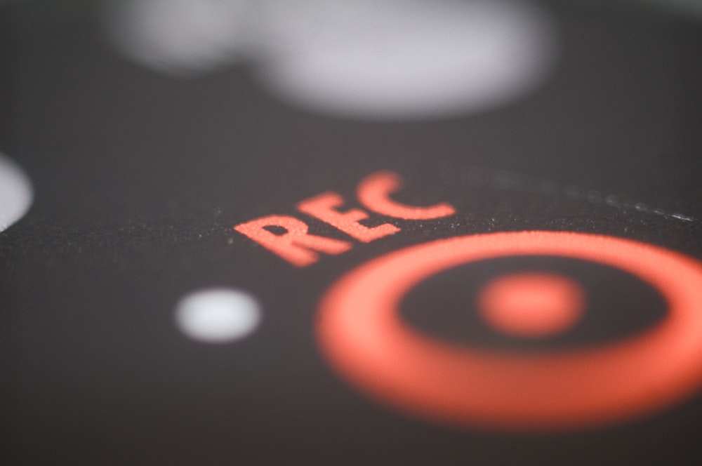 a close up of a red circle on a black surface