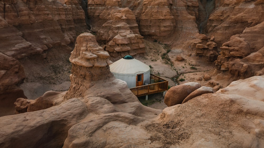 a yurt in the middle of a canyon surrounded by rocks