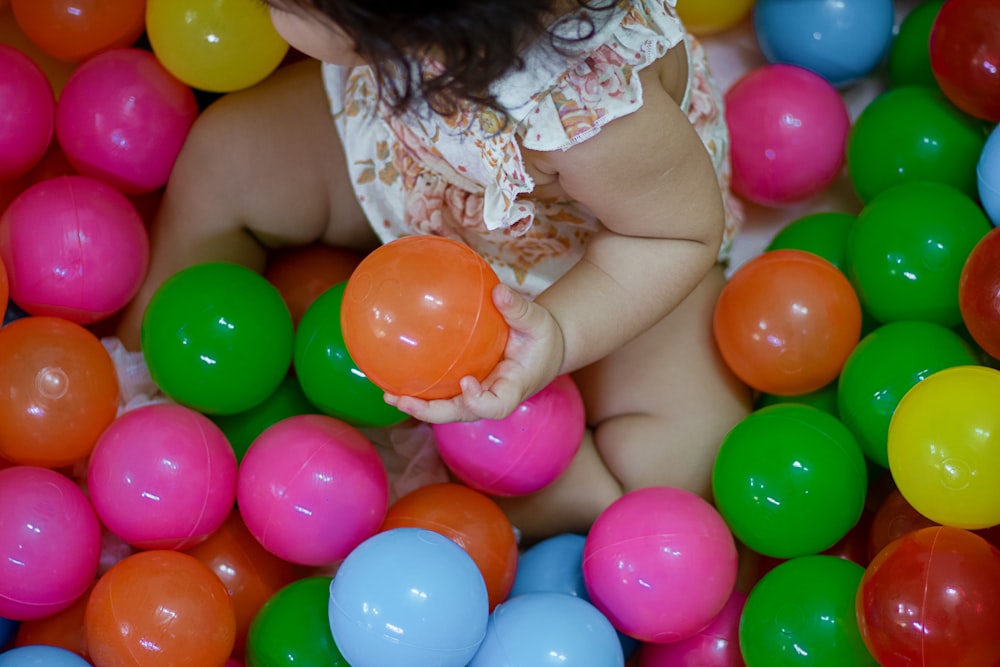 a baby is sitting in a ball pit