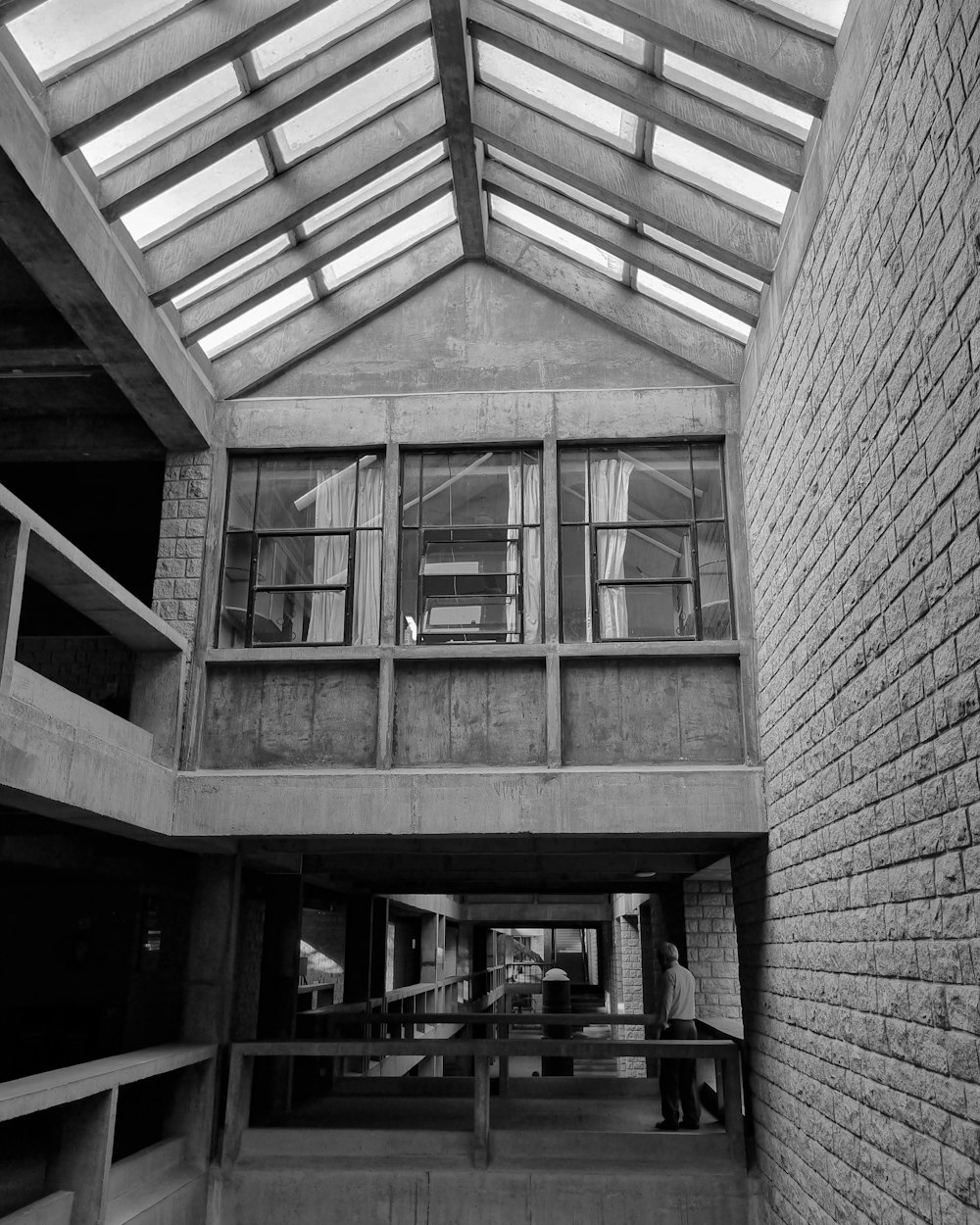 a black and white photo of a building with a skylight