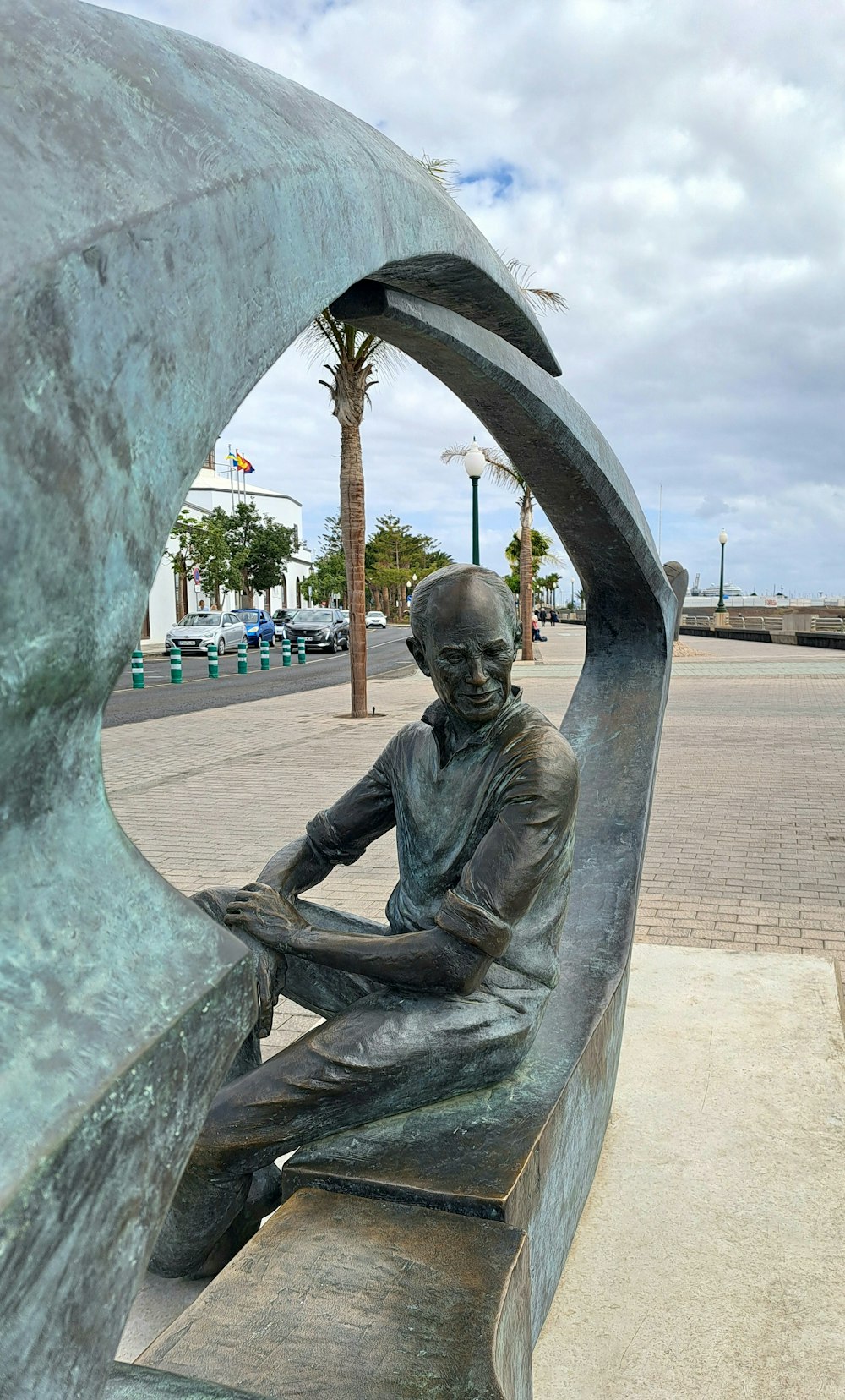 a statue of a man sitting on a bench