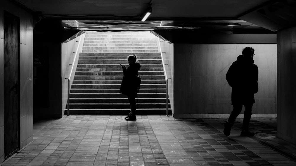 a couple of people that are standing in front of some stairs