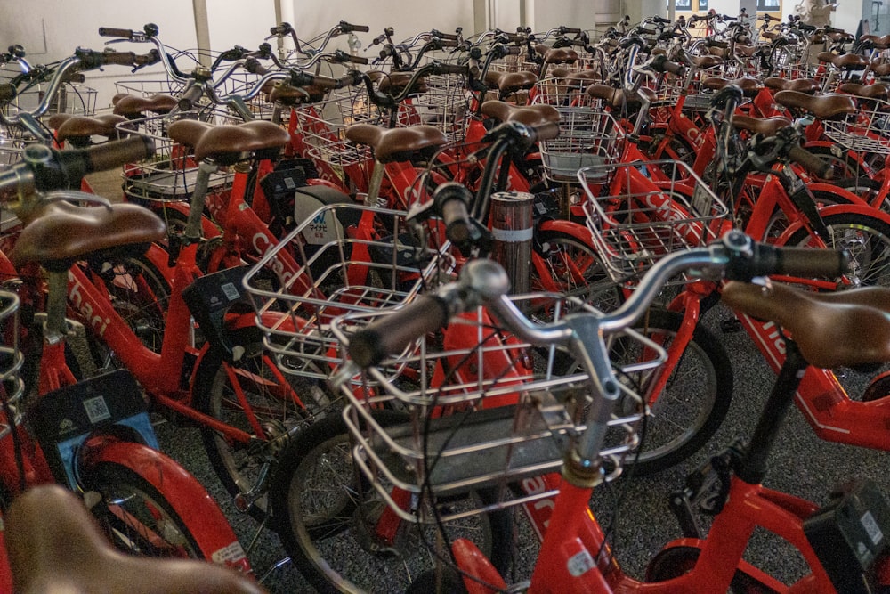 a large room filled with lots of red bikes