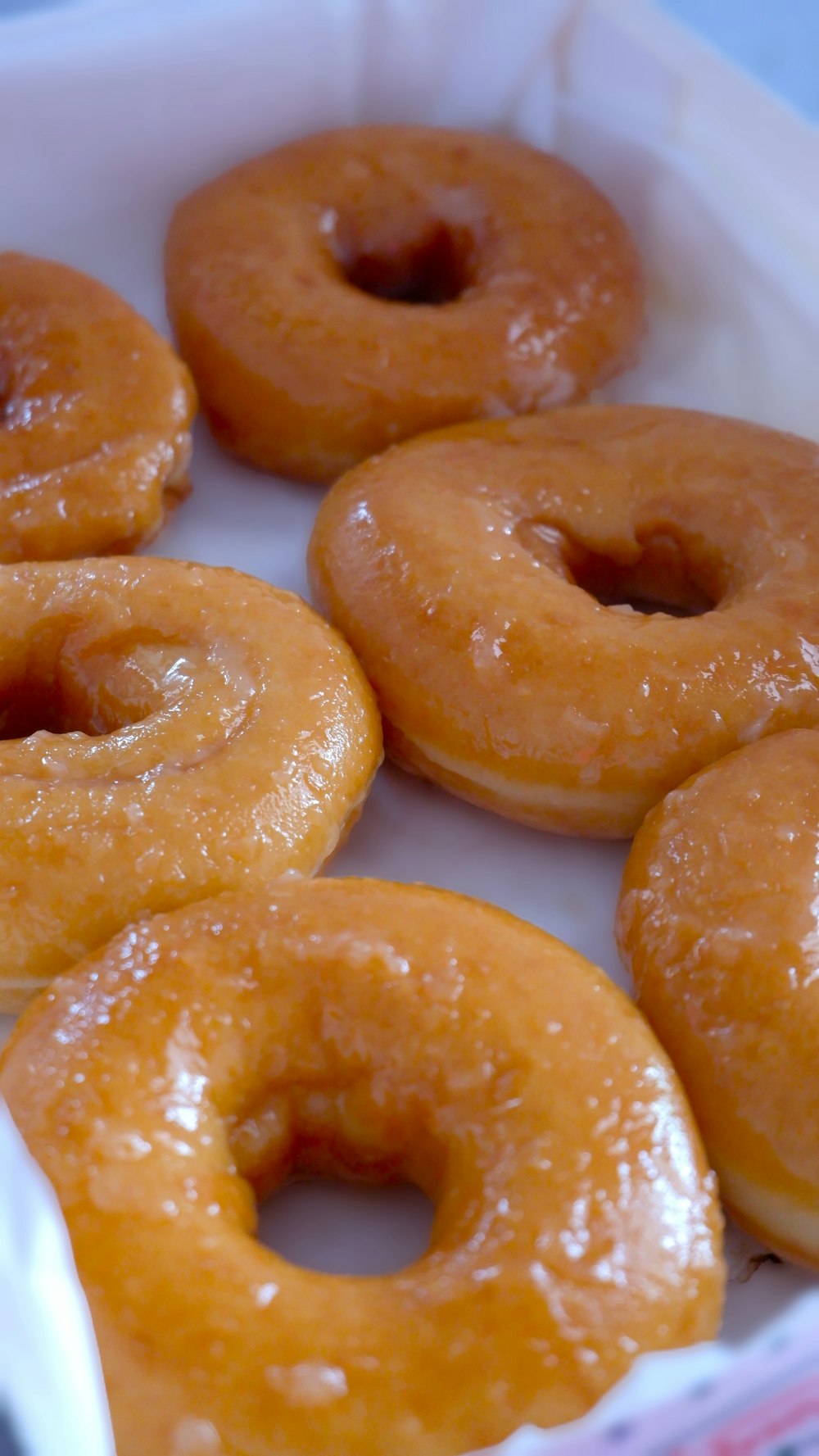 a bunch of glazed donuts in a box