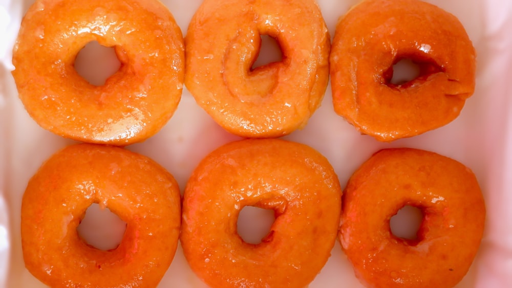 six glazed donuts in a white box