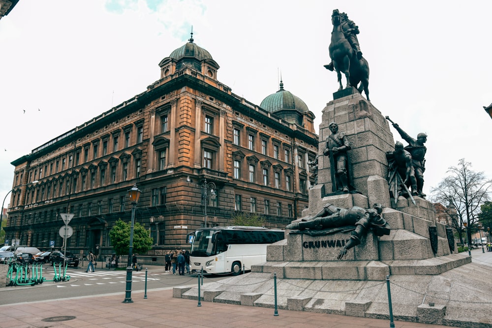 a statue of a man on a horse in front of a building