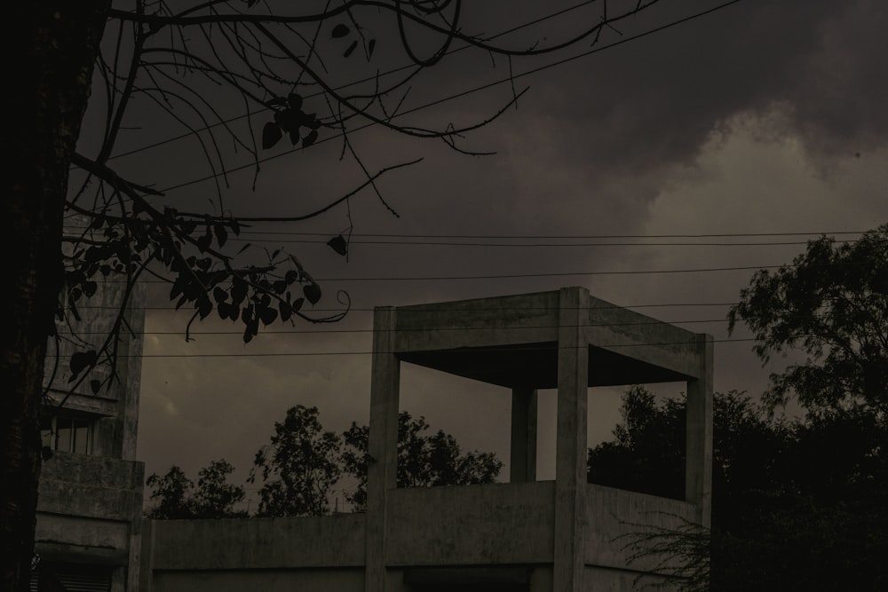 a dark picture of a building with a clock on it