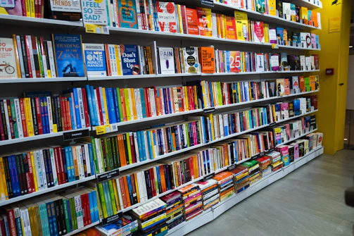 a bookshelf filled with lots of colorful books