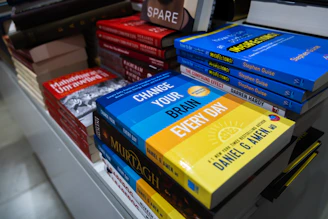 a bunch of books that are on a shelf