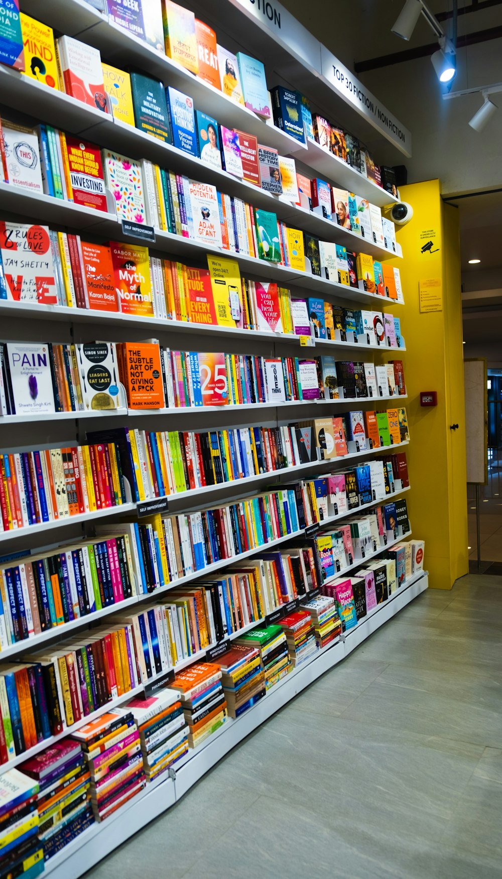 a bookshelf filled with lots of colorful books