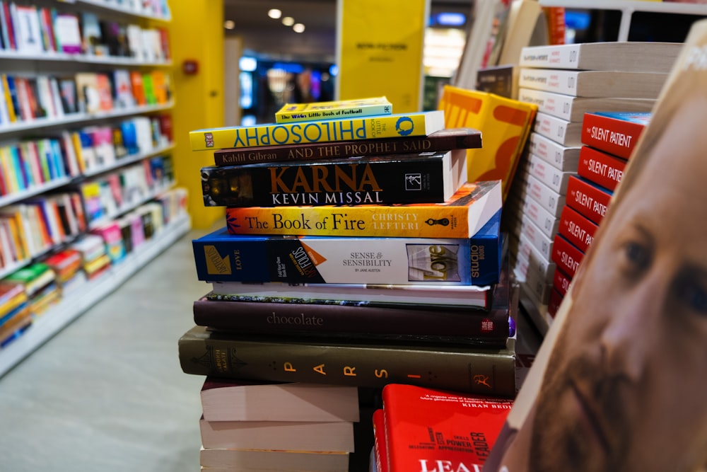 a pile of books sitting on top of a shelf