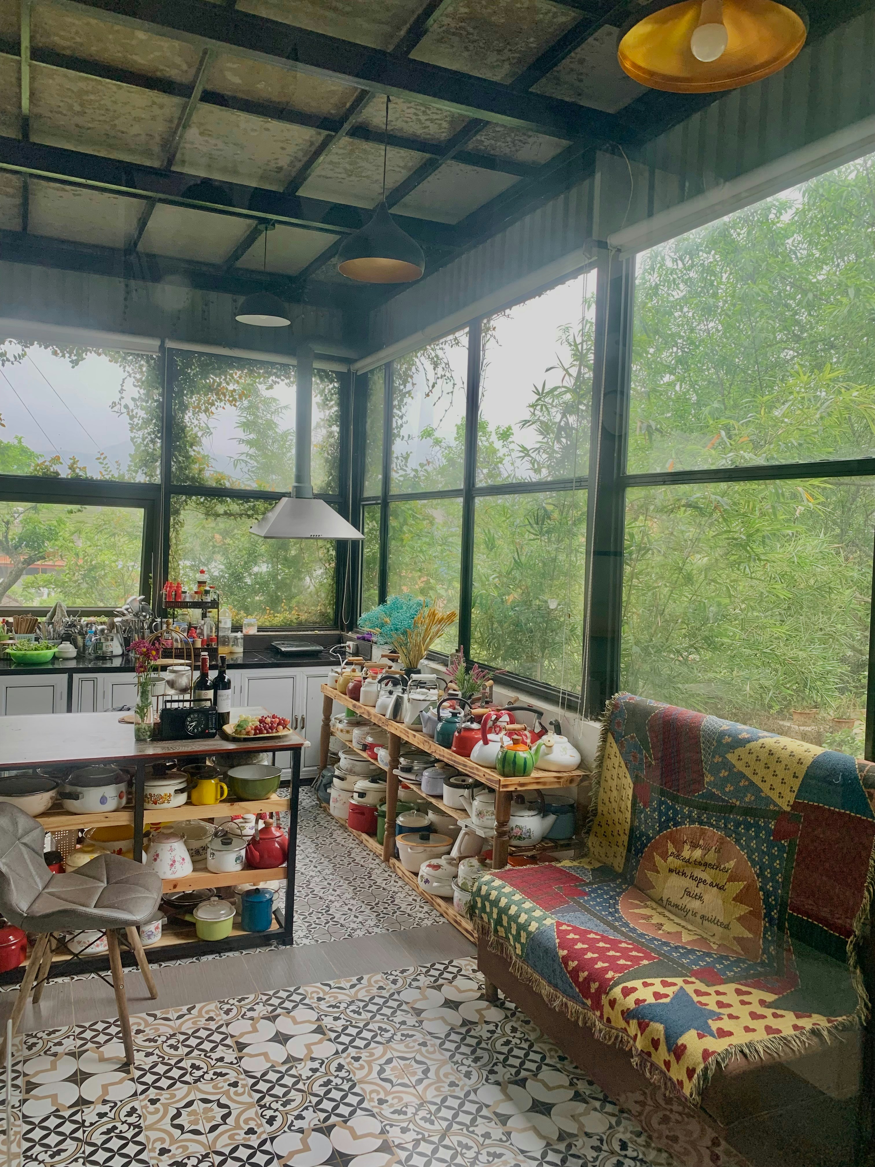 a room filled with lots of furniture and windows