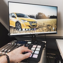 a person using a keyboard and mouse to type on a computer screen