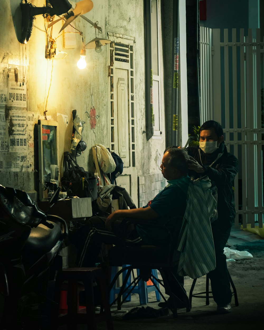 a man getting his hair cut in a barber shop