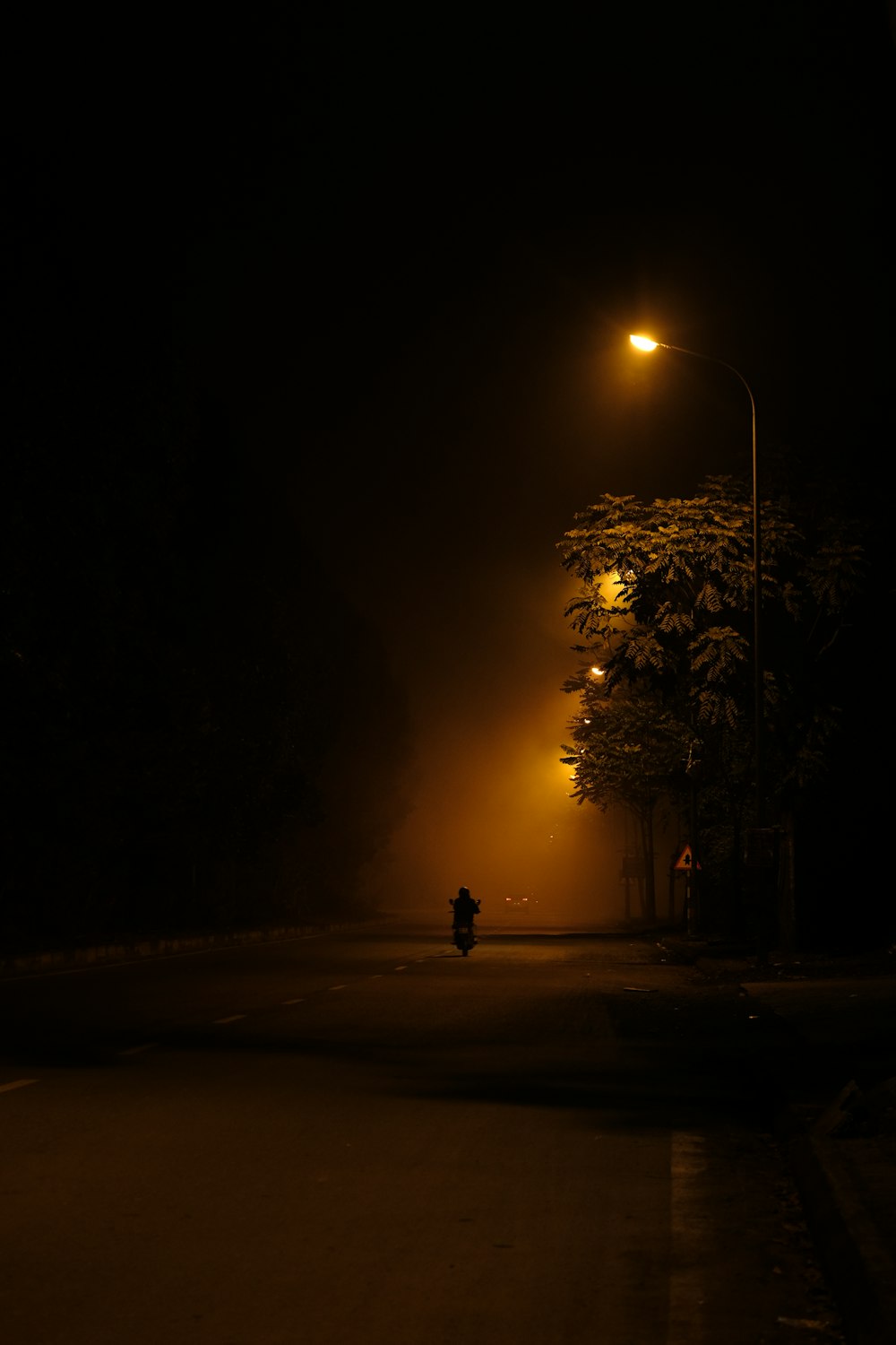 a person walking down a street at night