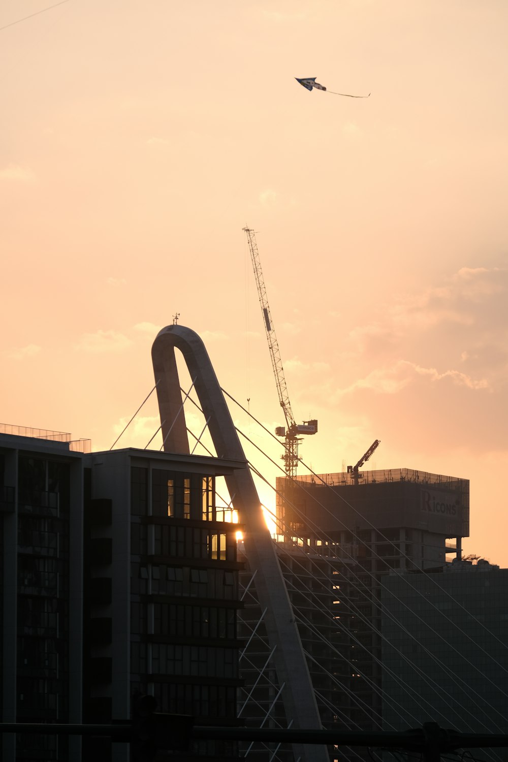 a plane flying over a building under construction