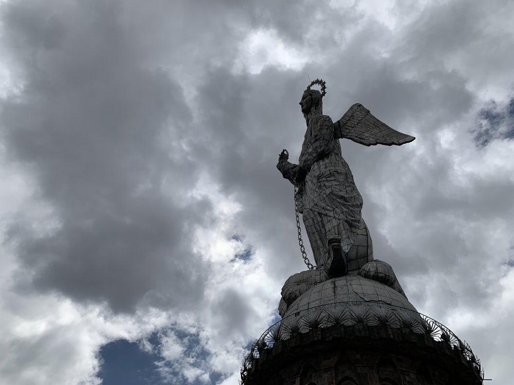 a statue of an angel on top of a building