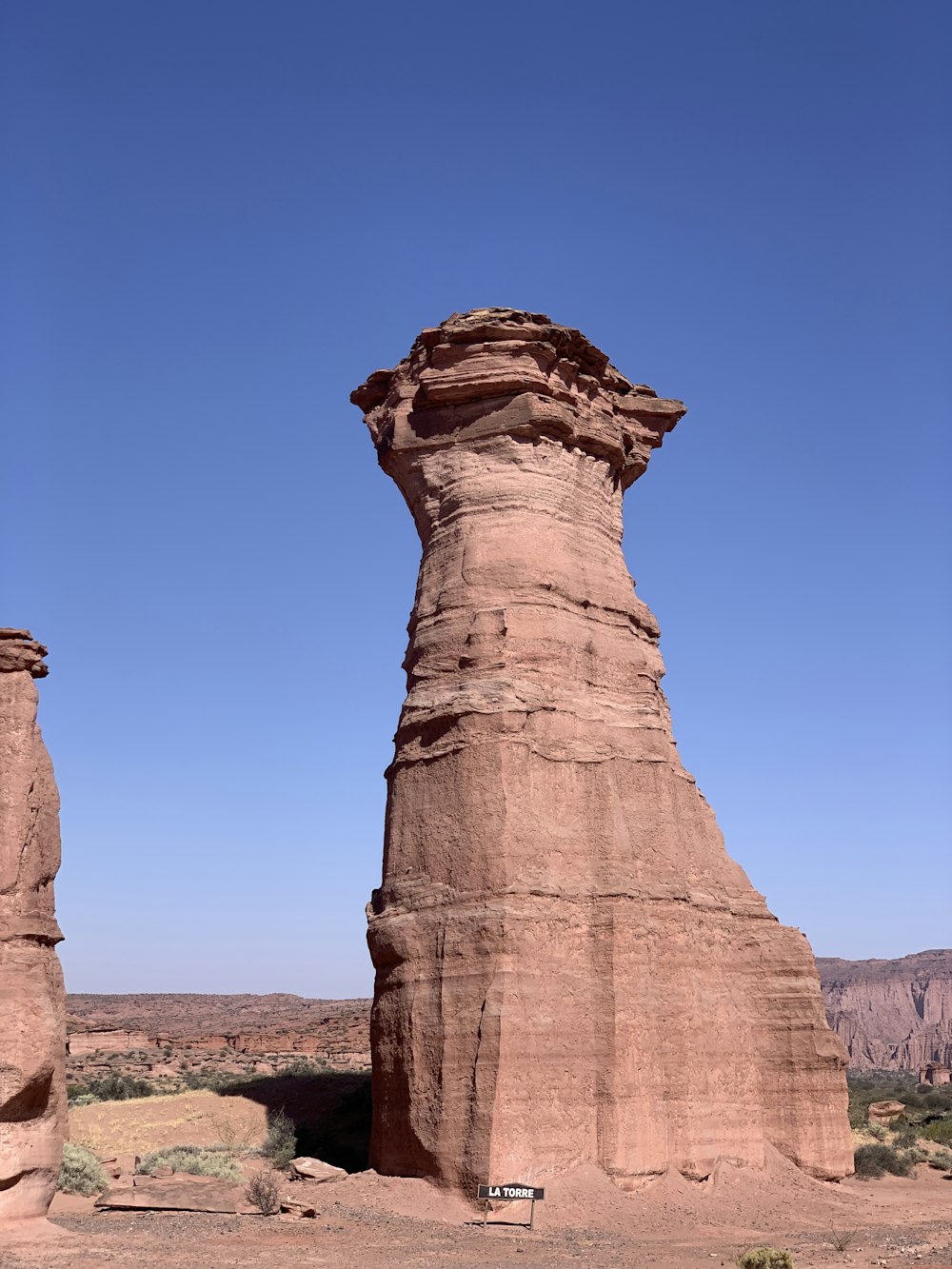 a large rock formation in the middle of a desert