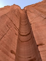 a very tall rock formation with a sky in the background