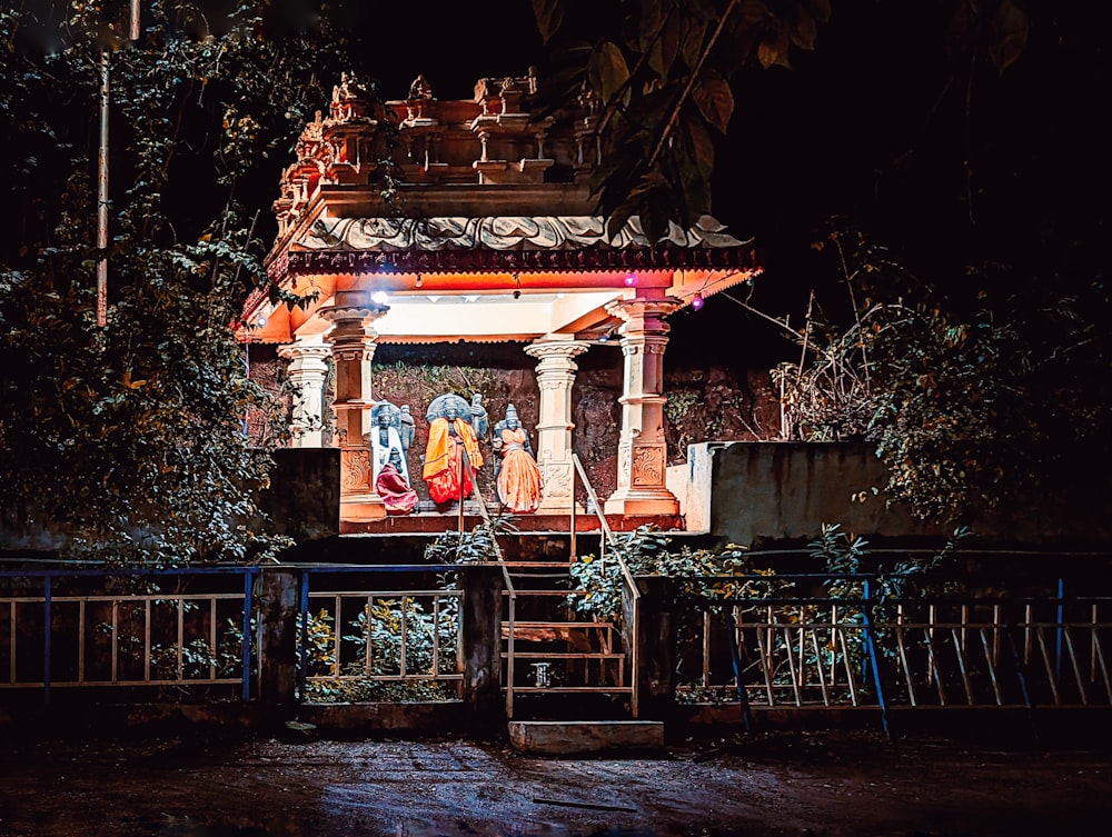 a lit up shrine in the middle of a forest
