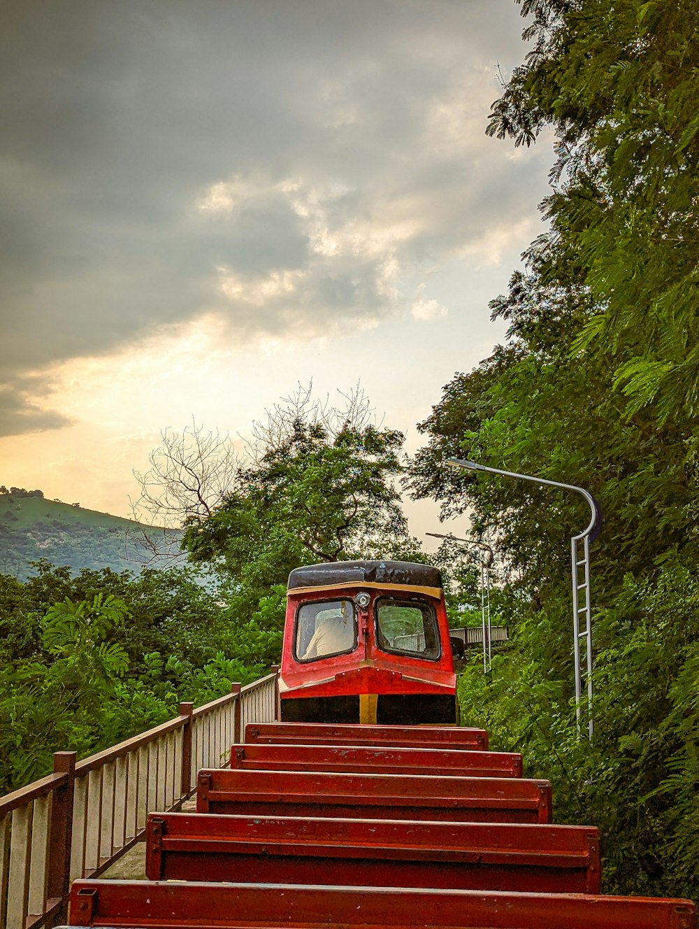 a red train traveling down a set of stairs