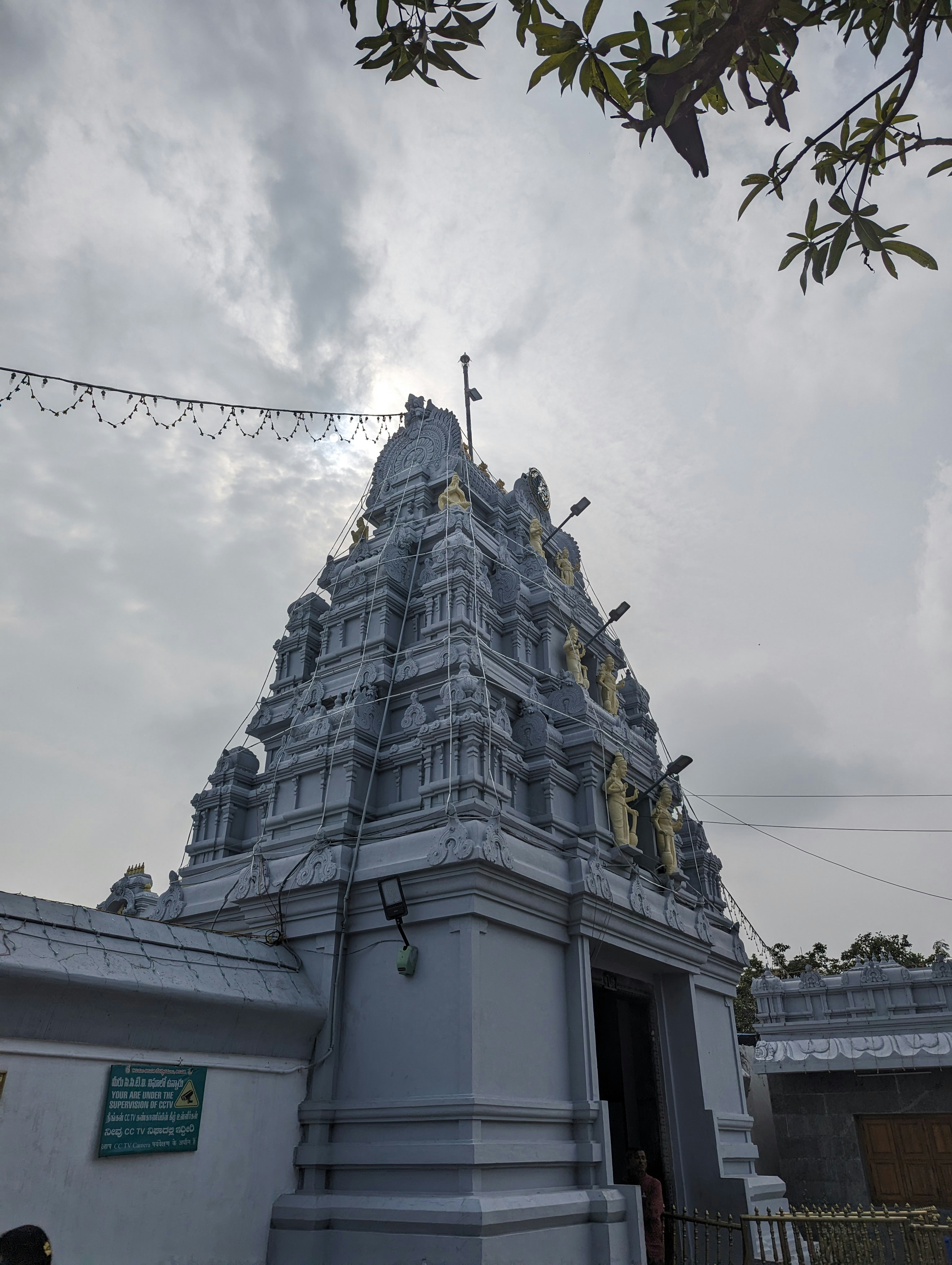 a very tall white building with a clock on it's side
