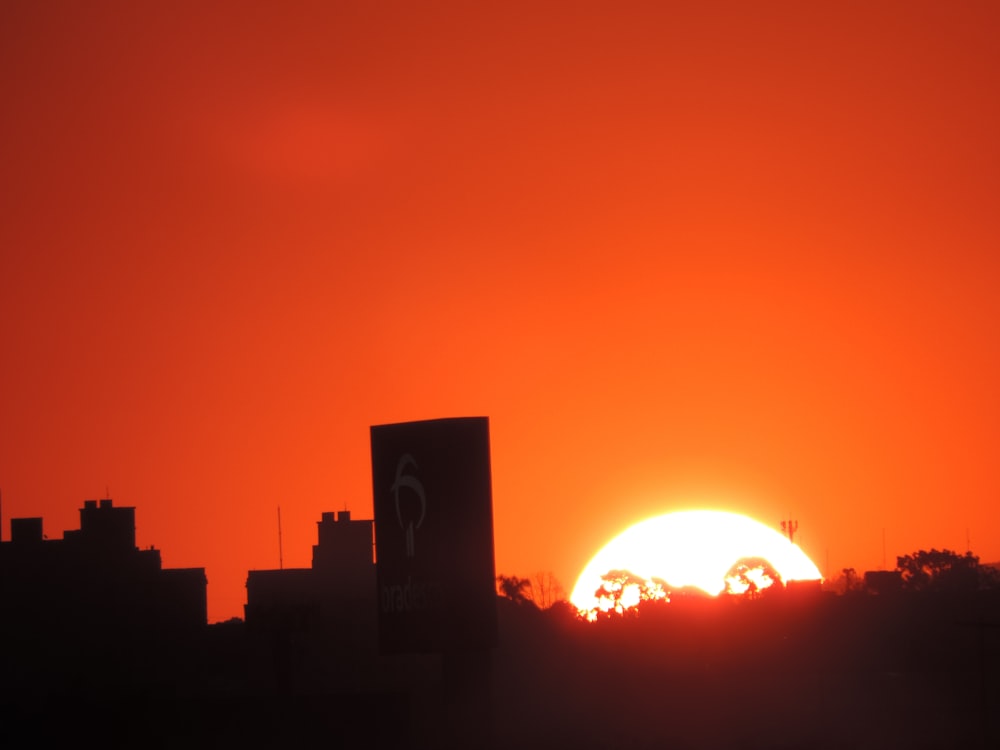 the sun is setting over a city skyline