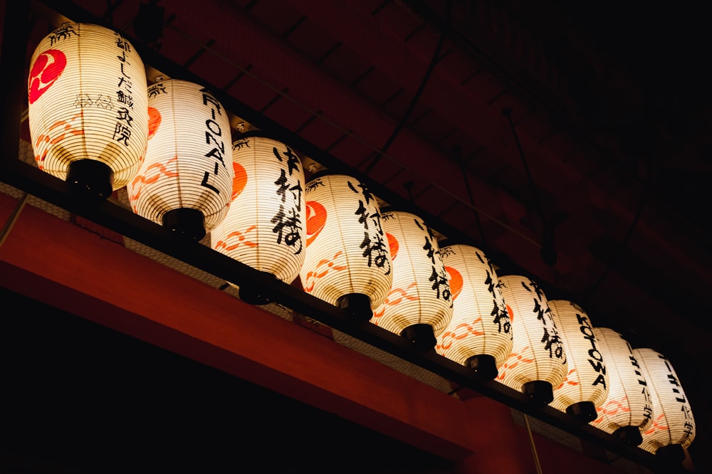 a row of paper lanterns hanging from a ceiling