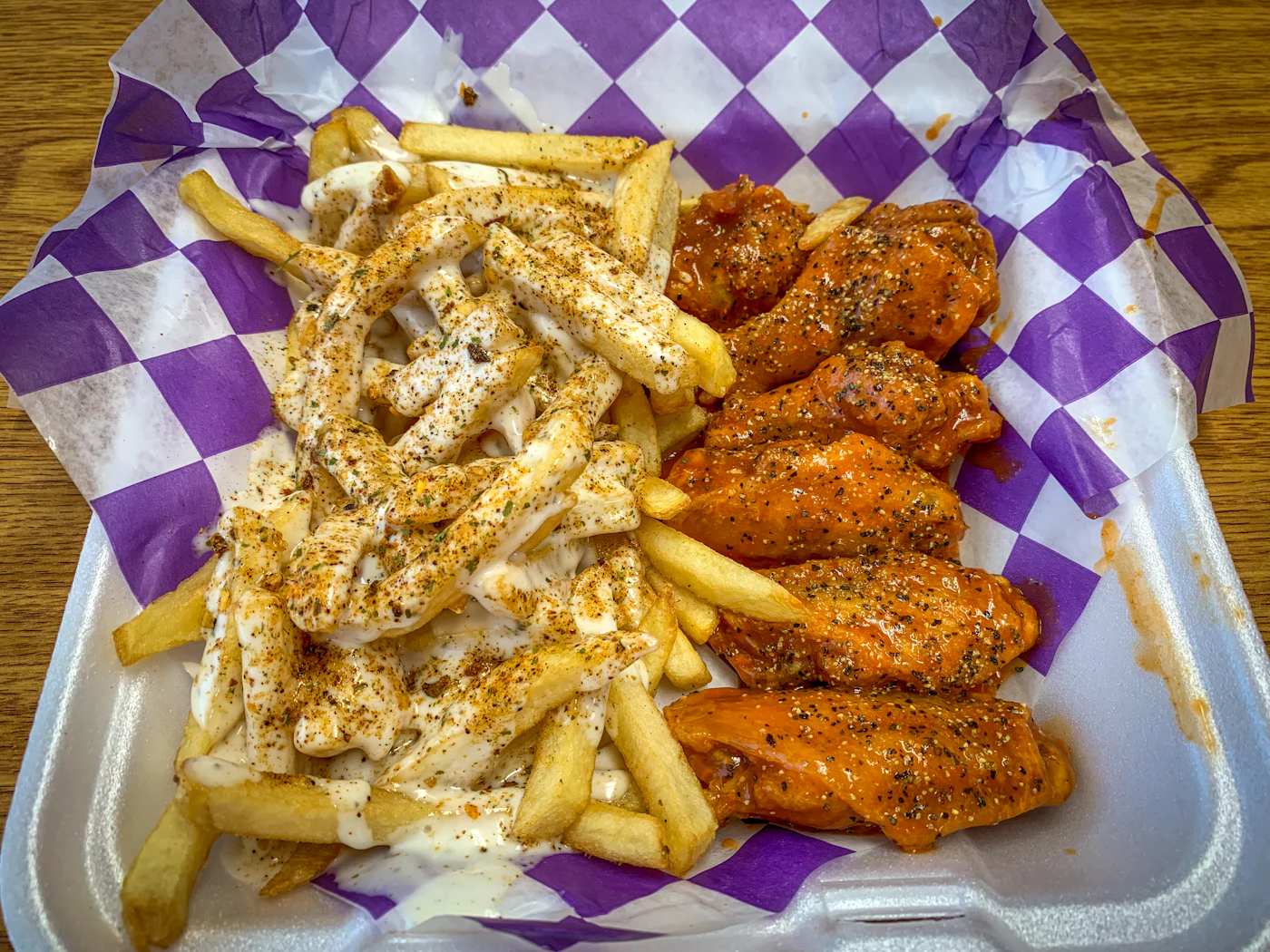 Chicken wings and fries on a tray