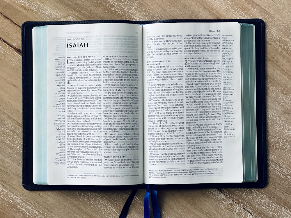 an open bible on a wooden table